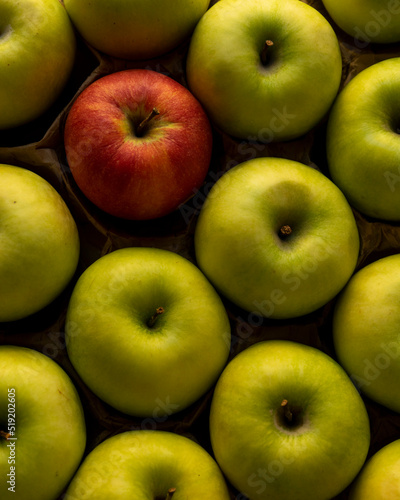 green apples in the market, and one red apple
