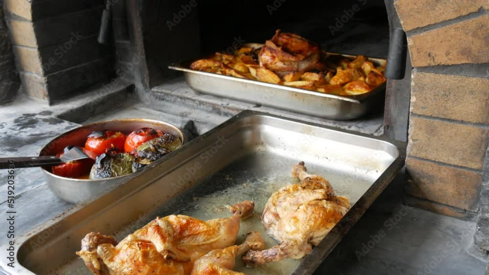 Freshly cooked dishes from a real oven. Fried chicken thighs, stuffed tomatoes, peppers and stewed potatoes. National Greek cuisine Freshly cooked dishes from a real oven. Fried chicken thighs, stuffed tomatoes, peppers and stewed potatoes. National Greek cuisine