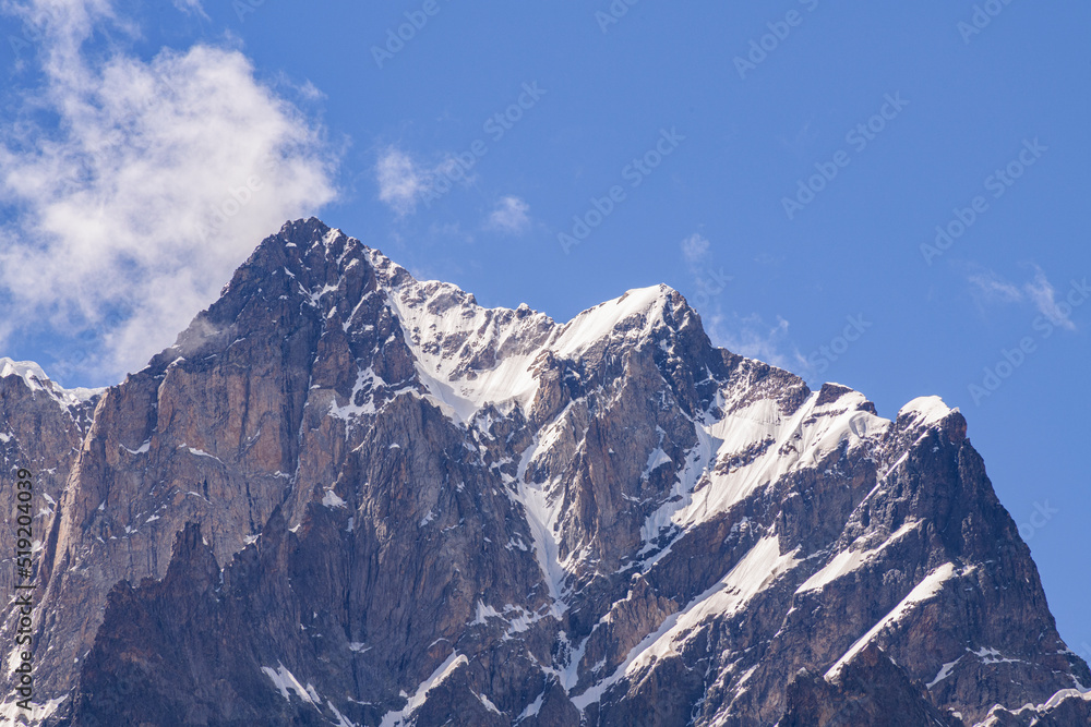 Mountains landscape. High snow covered mountains and rocks in the clouds.Georgia. Ushba mountains.