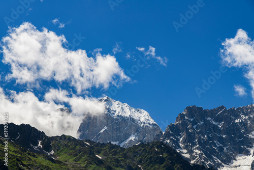 Mountains landscape. High snow covered mountains and rocks in the clouds.Georgia. Ushba mountains.