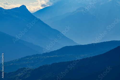 Panorama of mountains on the sunset. Beautiful blue mountains and hills.