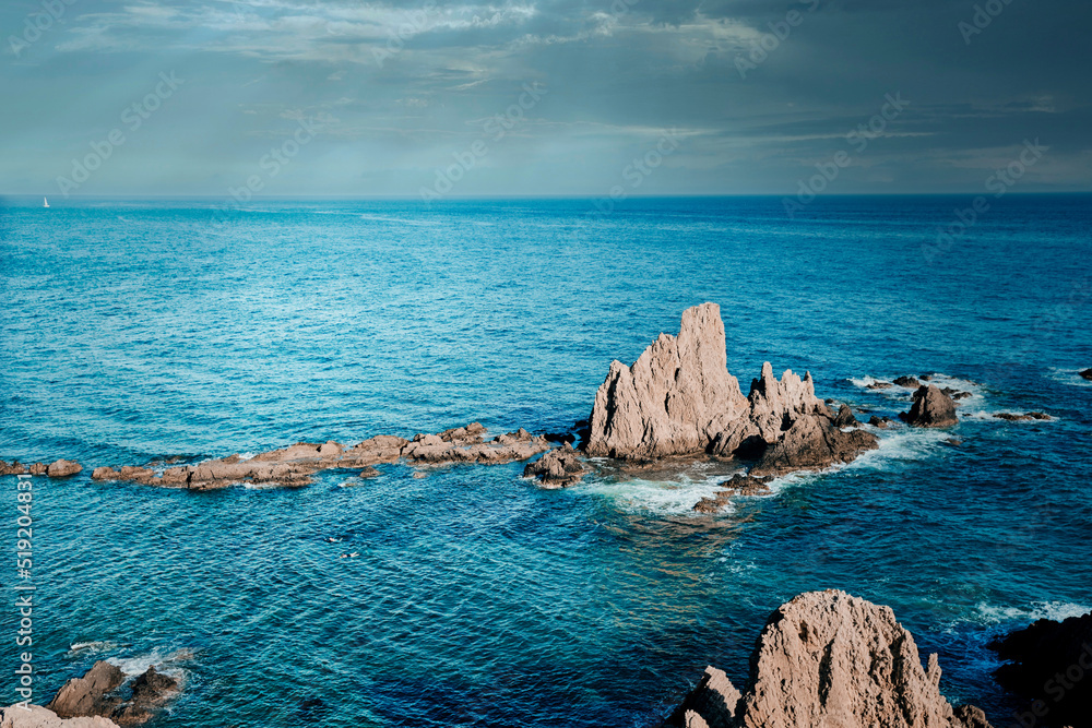 Panoramic seascape at sunset of the reef of the sirens, in Cabo de Gata, Almeria, Spain where you can see ancient volcanic lava chimneys millions of years old in the Mediterranean sea
