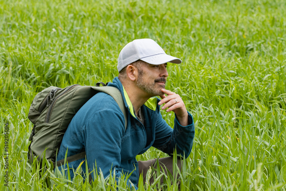 Happy man pensive in a field in the middle of nature. Happy man pensive in a field in the middle of nature.