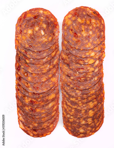 Chorizo sausage in slices, isolated. Meat cold cuts, spicy salami on white background. Packshot photo for package design