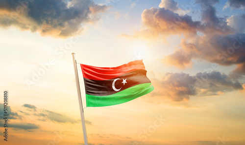 Libya national flag cloth fabric waving on the sky - Image