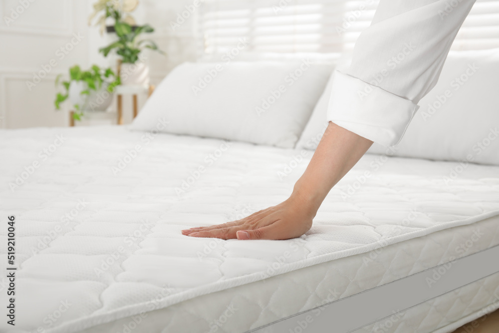 Woman touching soft white mattress on bed indoors, closeup - obrazy, fototapety, plakaty 