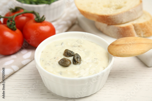 Εκτύπωση καμβά Creamy caper sauce in bowl on white wooden table, closeup