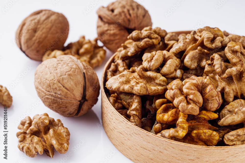 dried walnuts on a white acrylic background dried walnuts on a white acrylic background