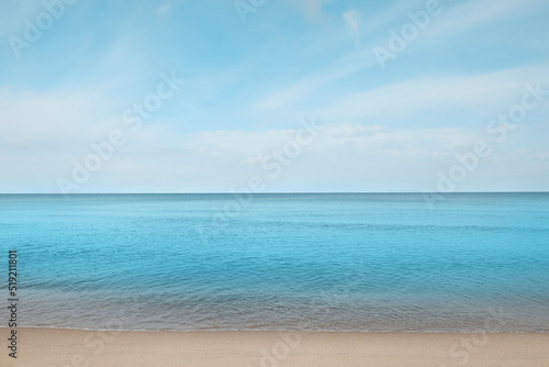 Beautiful view of sea shore under blue sky on sunny day