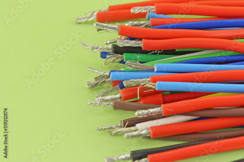 The electrical wire is copper in insulation on a colored background.