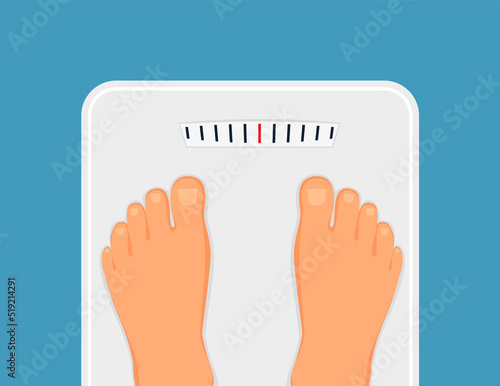 Woman is standing on bathroom scales,top view of feet. Weight measurement and control. Concept of healthy lifestyle, dieting and fitness
