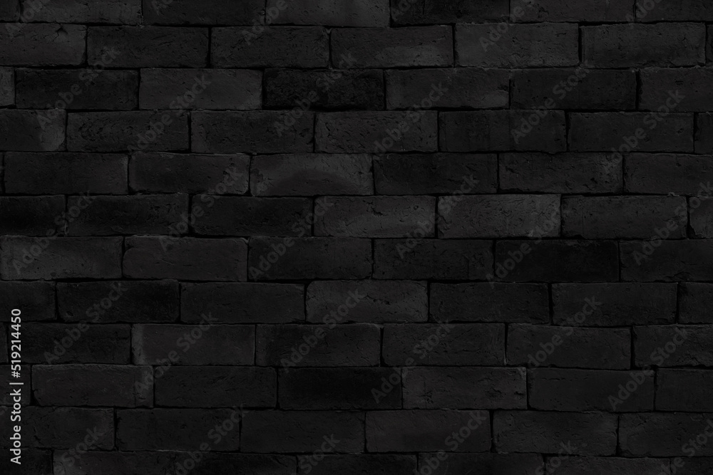 Black brick walls that are not plastered background and texture. The texture of the brick is black. Background of empty brick basement wall.                           