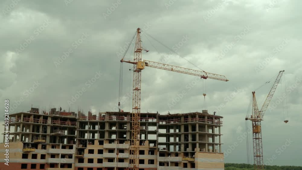 Construction site time lapse with crane working on buildings. Construction of an apartment building in cloudy weather. Construction site time lapse with crane working on buildings. Construction of an apartment building in cloudy weather.