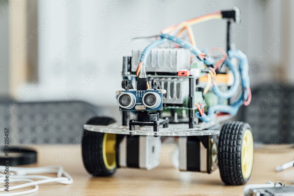 Close up view of the cute robot in the room without people. Creating robot at lab and modern technology for kids concept. Stem education Close up view of the cute robot in the room without people. Creating robot at lab and modern technology for kids concept. Stem education