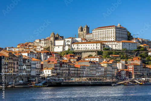 City of Oporto, Portugal in the margins of the Douro river. Douro river in the city of Oporto with traditional boats to transport the famous Oporto Wine from the wineries up river