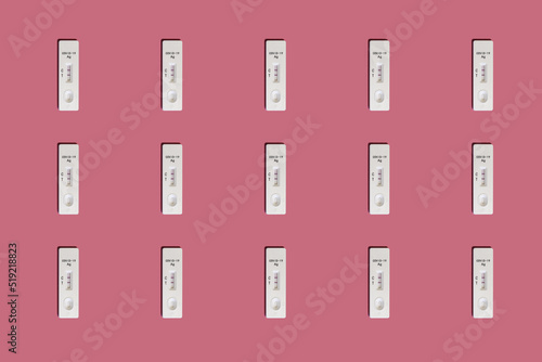 Positive Covid-19 antigen test pattern on pink background with harsh shadows