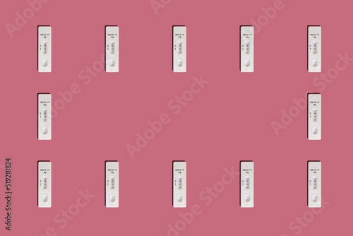 Positive Covid-19 antigen test pattern frame on pink background with harsh shadows