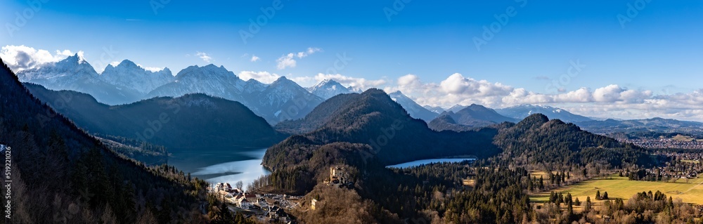 Panorama view of the Bavarian Alps and Lake with the famous Hohenschwangau Castle and Alpsee lake, Schwansee lake on a sunny day in winter, Schwangau, Bavaria, Germany