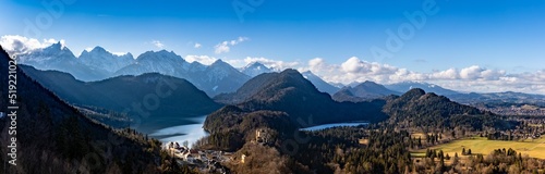 Panorama view of the Bavarian Alps and Lake with the famous Hohenschwangau Castle and Alpsee lake, Schwansee lake on a sunny day in winter, Schwangau, Bavaria, Germany