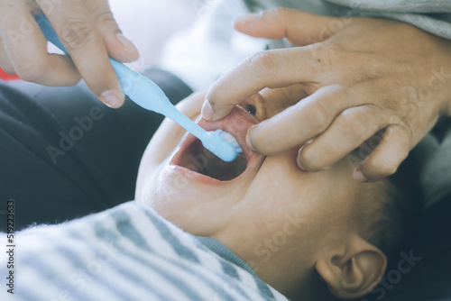 Boy doesn't like brushing his teeth and is sad, baby with her mother and brushing teeth