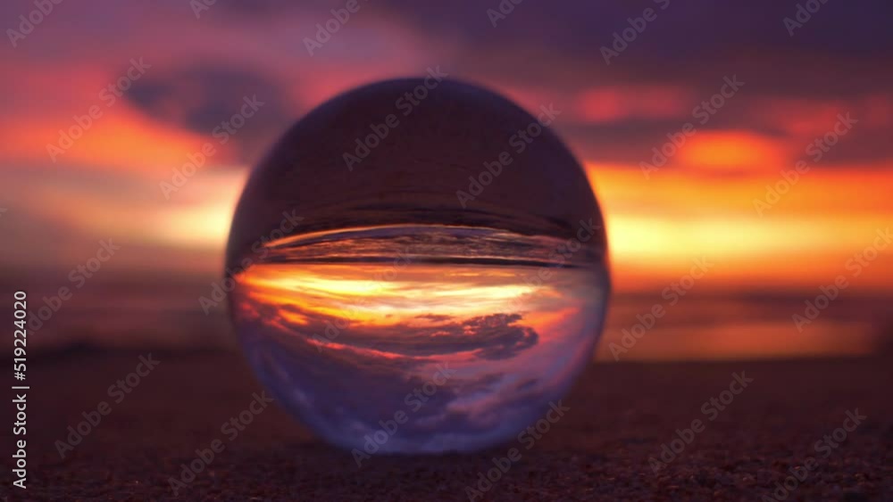 view of colorful nature at sunset inside crystal ball..beautiful sunset over sea in a crystal ball on the beach video 4K. .Nature video High quality footage in nature and travel concept. view of colorful nature at sunset inside crystal ball..beautiful sunset over sea in a crystal ball on the beach video 4K. .Nature video High quality footage in nature and travel concept.