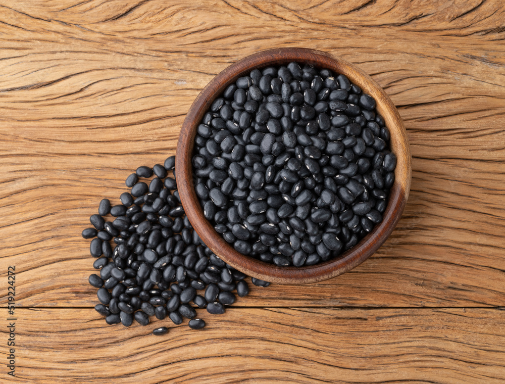 Black beans in a bowl over wooden table Black beans in a bowl over wooden table