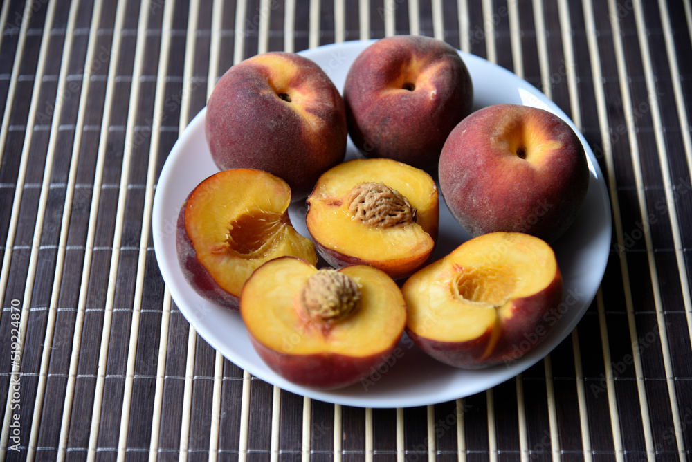 Sliced juicy delicious peaches on a mat close-up. Sliced juicy delicious peaches on a mat close-up.