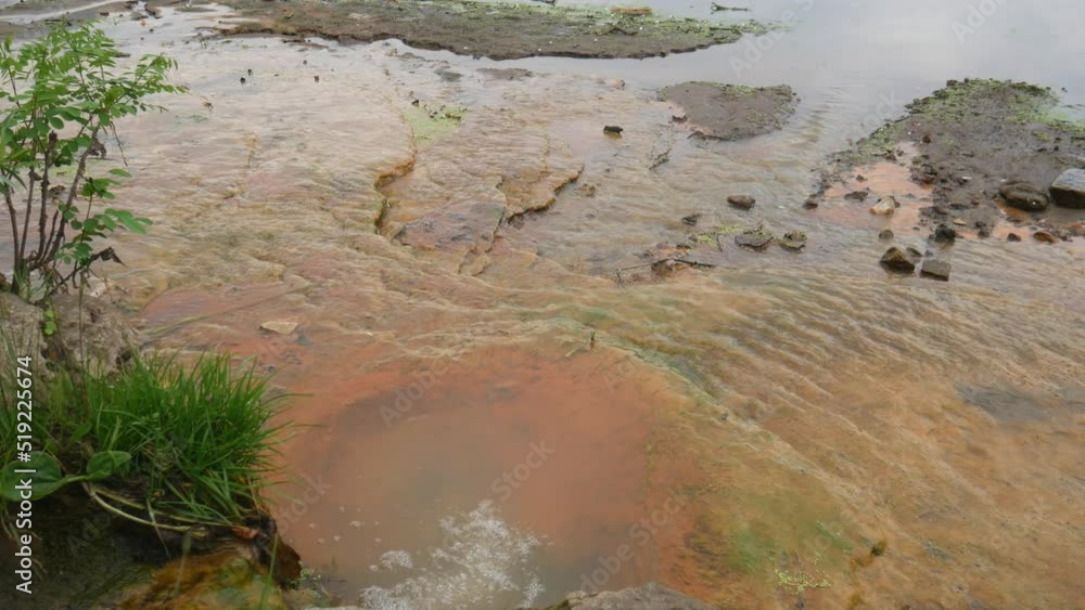 Draining sewage from pipe into river, pollution rivers and ecology
