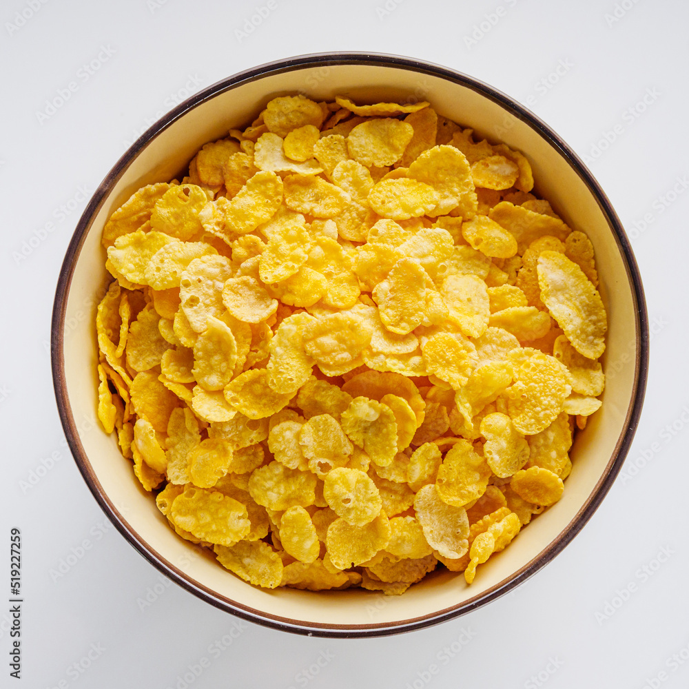 crispy golden cornflakes on a white acrylic background crispy golden cornflakes on a white acrylic background