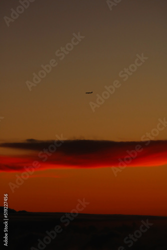 Plane over a cloud in sunset