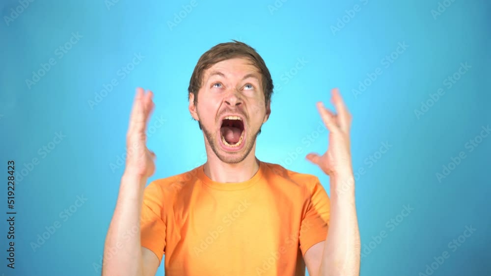 Video „Portrait of angry furious man screaming with anger closing his ...