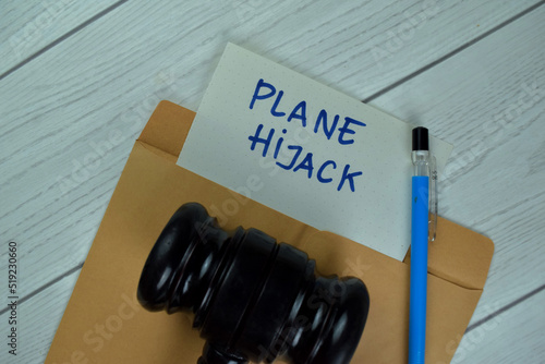 Foto Plane Hijack text on document above brown envelope with gavel.
