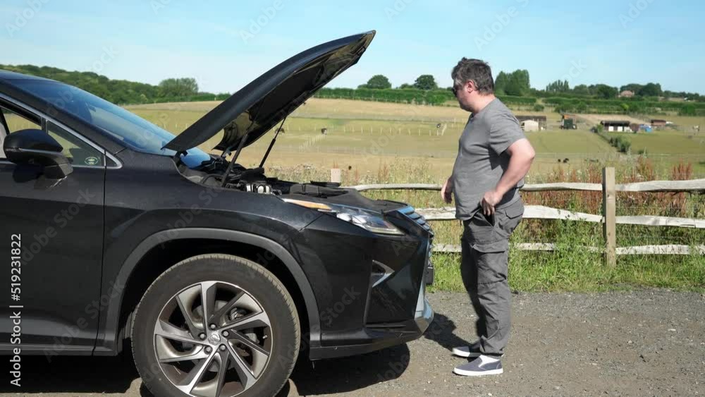 Frustrated Man Repairing Accident Car. Sad Disappointed Male On Broken Car. Vehicle Check Engine Damage Troubles. Driver Calls Emergency Services on Phone. Auto Accident. Open Hood Automobile Motor Frustrated Man Repairing Accident Car. Sad Disappointed Male On Broken Car. Vehicle Check Engine Damage Troubles. Driver Calls Emergency Services on Phone. Auto Accident. Open Hood Automobile Motor