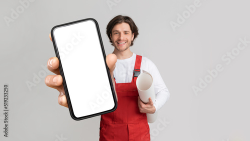 Worker Holding Construction Plan And Smartphone With Blank Screen