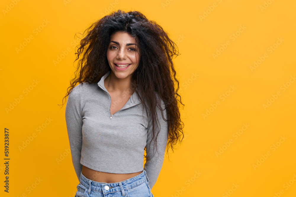 Close up young happy smiling woman 20s with culry hair wear casual clothes isolated on plain yellow background studio portrait. People lifestyle concept. Copy space, free place, mockup, banner