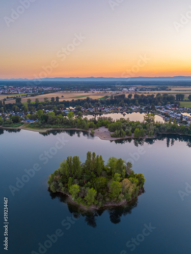 Aerial View on a little island in the quarry lake Binsfeldsee at Speyer in Germany. © David Hajnal