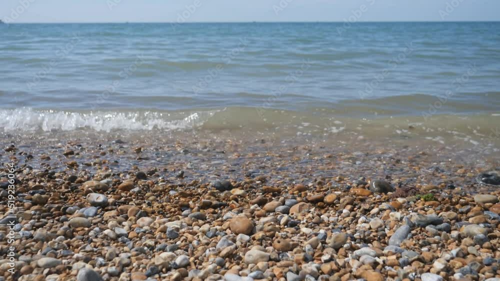 Sea waves calmly crushing on the pebble beach. Sea waves calmly crushing on the pebble beach.