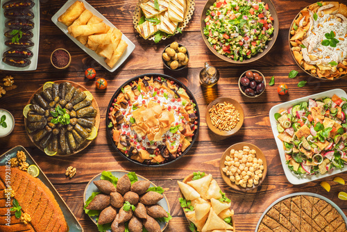 Arabic Cuisine;Middle Eastern traditional dishes and assorted meze. Vine leaves, kibbeh, chicken fatteh, spring rolls, sambusak, kibbeh nayyeh, makdous, haloumi, olives, eggplant fatteh and salads. photo