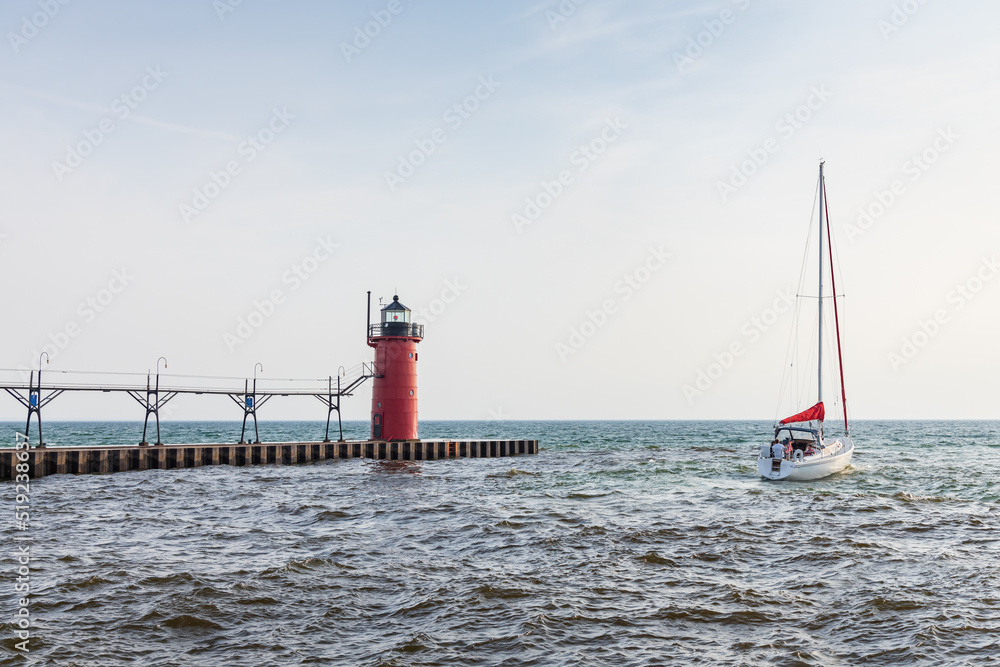 Sailboat in the channel and South Haven Pier Lighthouse, South Haven, Michigan
