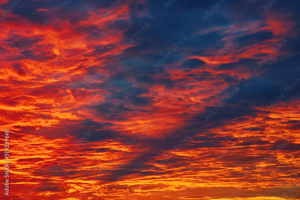 Dramatic bloody sky. Fiery sunset, sky on fire. Armageddon, apocalypse, heaven and hell, abstract dark red background. Red colorful glowing sky, vivid clouds at twilight. Majestic orange sundown.