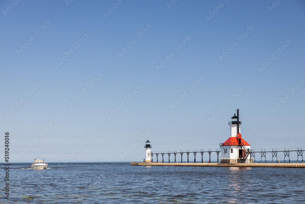 Boat in the channel and St. Joseph North Pier Inner Lighthouse and St. Joseph North Pierhead Outer Lighthouse, Michigan Boat in the channel and St. Joseph North Pier Inner Lighthouse and St. Joseph North Pierhead Outer Lighthouse, Michigan