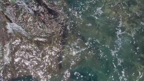 Wallpaper Mural The waves crash against the rocky sea coast. Top view, water mixed with foam. Torontodigital.ca