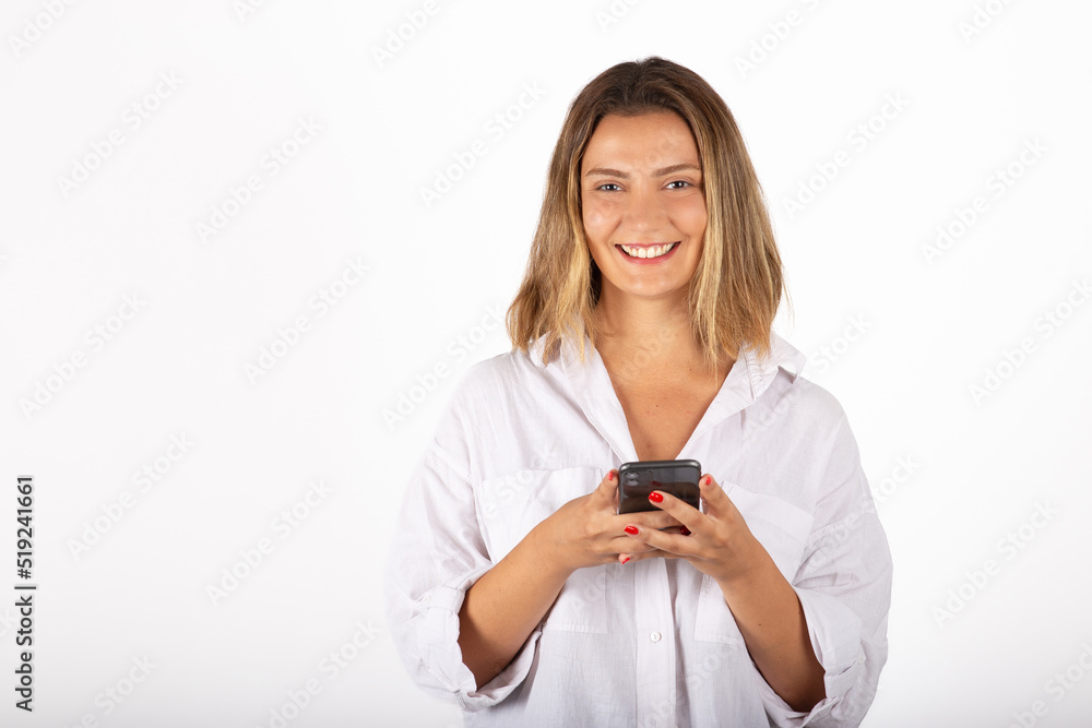 Young businesswoman portrait with smartphone in studio. Young businesswoman portrait with smartphone in studio.
