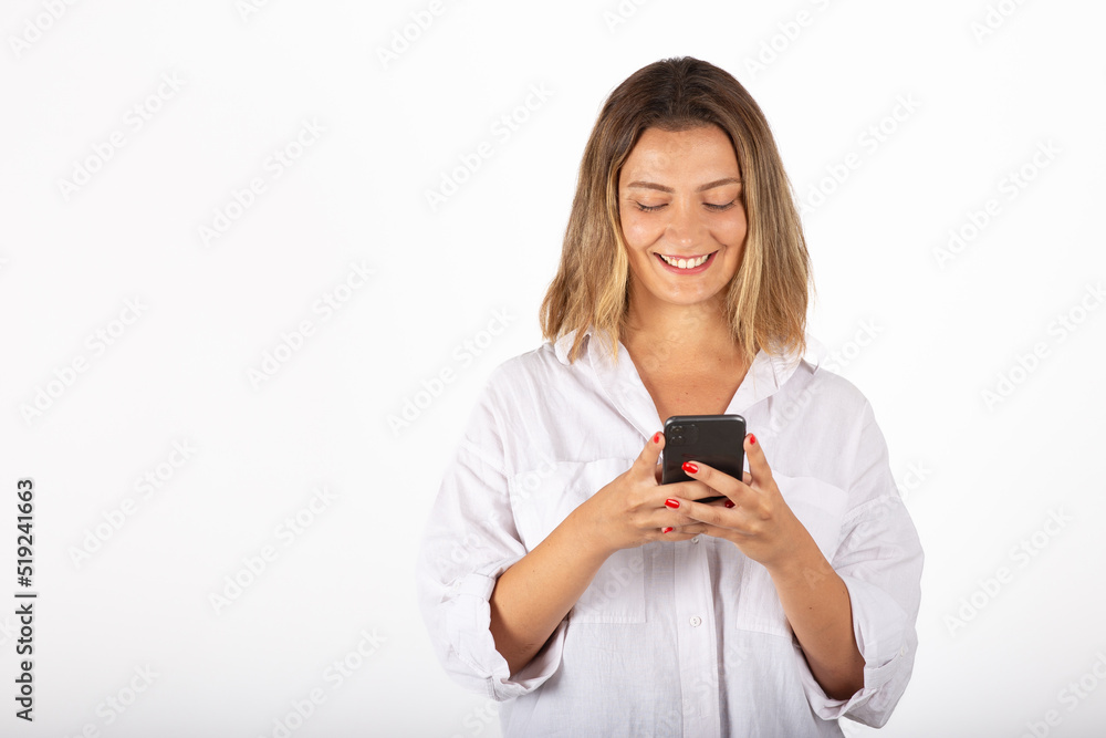 Young businesswoman portrait with smartphone in studio. Young businesswoman portrait with smartphone in studio.