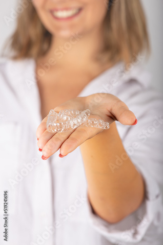 Beautiful smiling young woman with aligner.