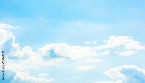 A vast light blue sky with freedom shape of fluffy clouds floating over the air. Soft and pure cloudy in sunny day, calm and tranquil nature scene. Abstract background of natural cloudscape.