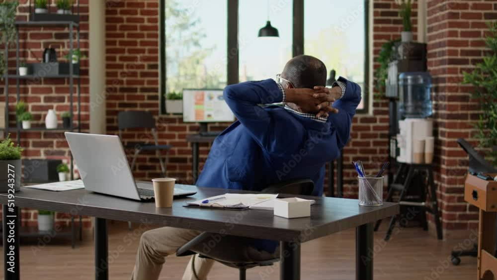 Businessman relaxing at office desk after working on project, sitting laid back on chair. Taking break from job feeling exhausted and overworked, timeout pause to relieve stress. Businessman relaxing at office desk after working on project, sitting laid back on chair. Taking break from job feeling exhausted and overworked, timeout pause to relieve stress.
