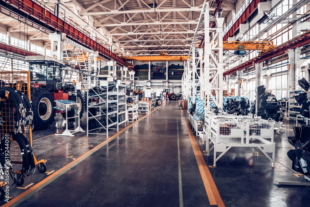 Fototapeta premium Assembly workshop at big industrial plant. Tractor assembling