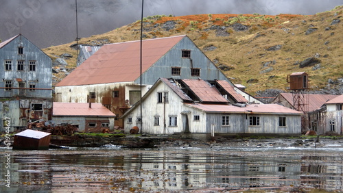 Fotografie Derelict, rusted buildings along the shore at the old whaling station at Leith H