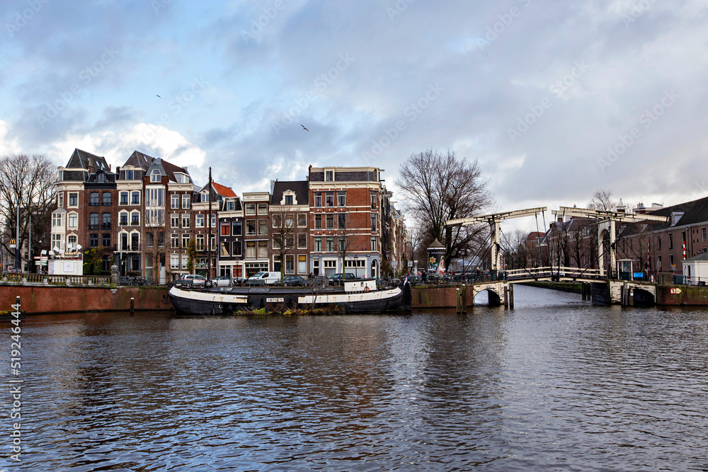 Typical Amsterdam cityscape. Amsterdam canals, boats and dutch architecture, Netherlands